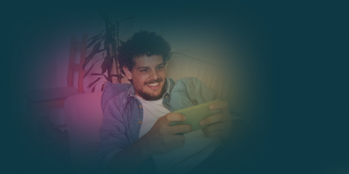 Smiling man using mobile at home.